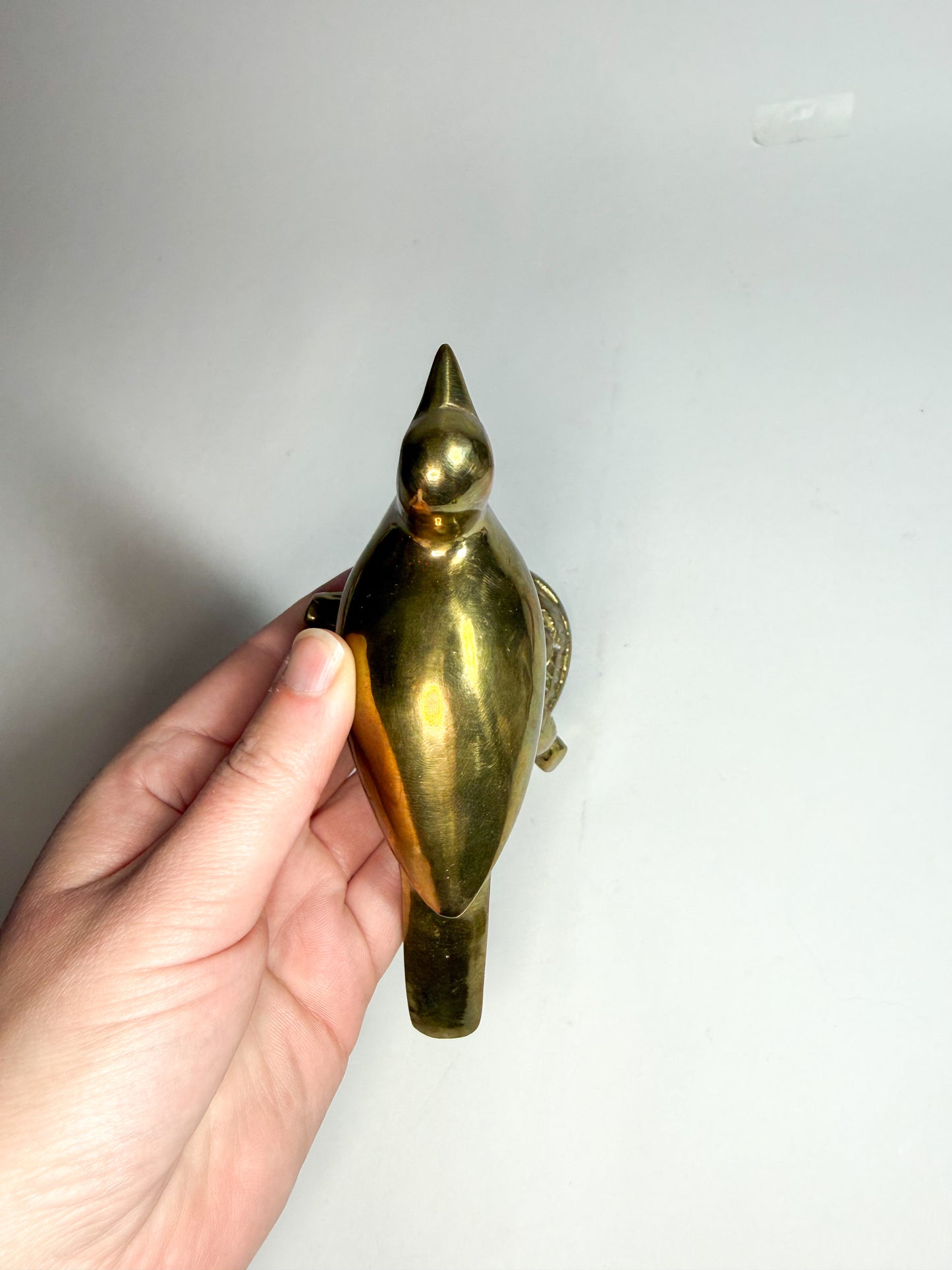 Brass bird on branch