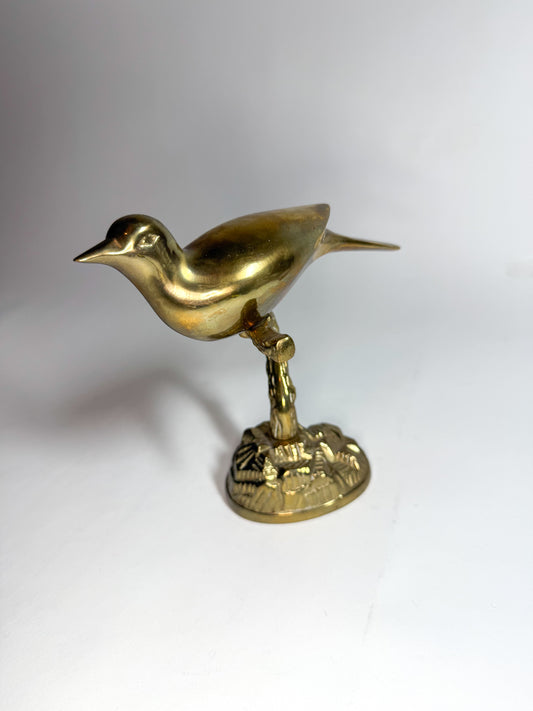 Brass bird on branch