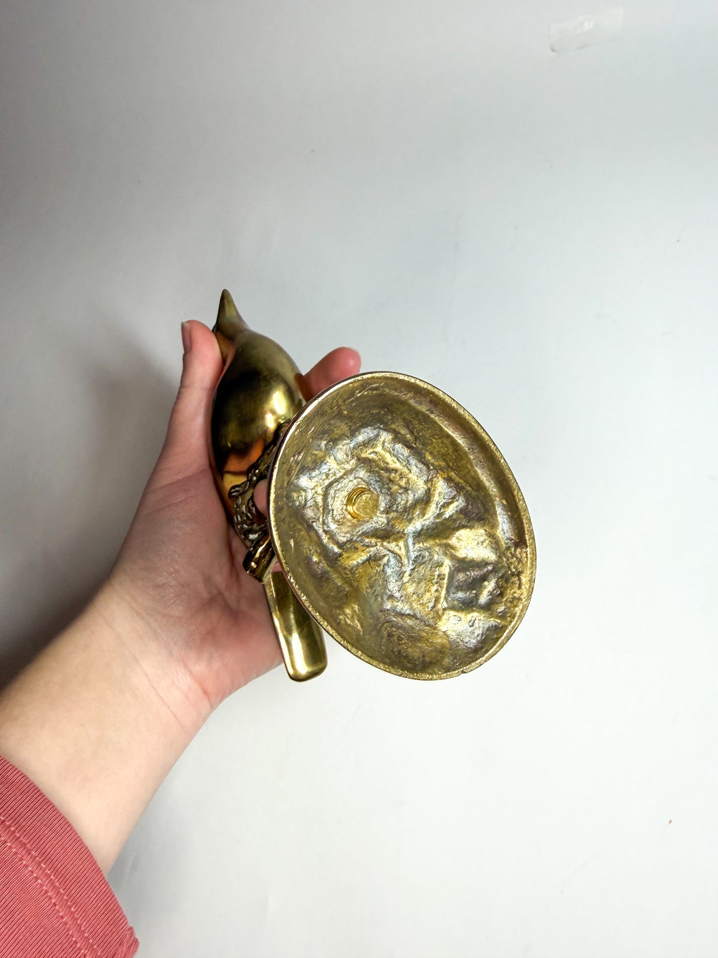 Brass bird on branch